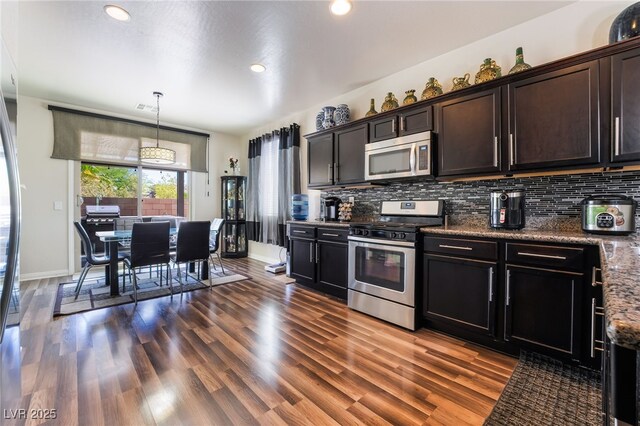 184 Cullerton St, Las Vegas, NV 89148 - kitchen with appliances with stainless steel finishes, backsplash, dark wood-style flooring, baseboards, and recessed lighting