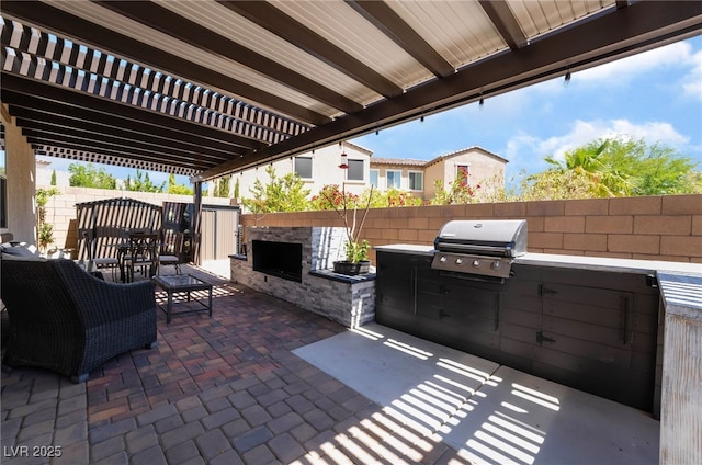 184 Cullerton St, Las Vegas, NV 89148 - view of patio with area for grilling, an outdoor stone fireplace, fence, a grill, and a pergola