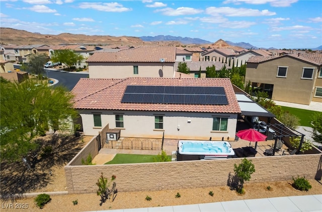 184 Cullerton St, Las Vegas, NV 89148 - rear view of property with roof mounted solar panels, a patio area, a tiled roof, a mountain view, and stucco siding