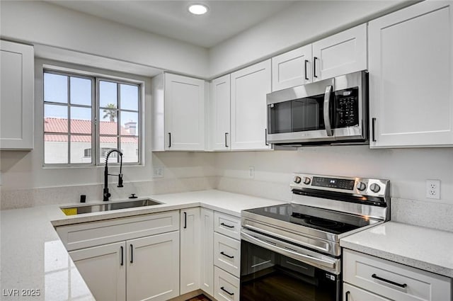 2725 S Nellis Blvd Unit 2036, Las Vegas, NV 89121 - kitchen featuring stainless steel appliances, a sink, white cabinetry, recessed lighting, and light stone countertops