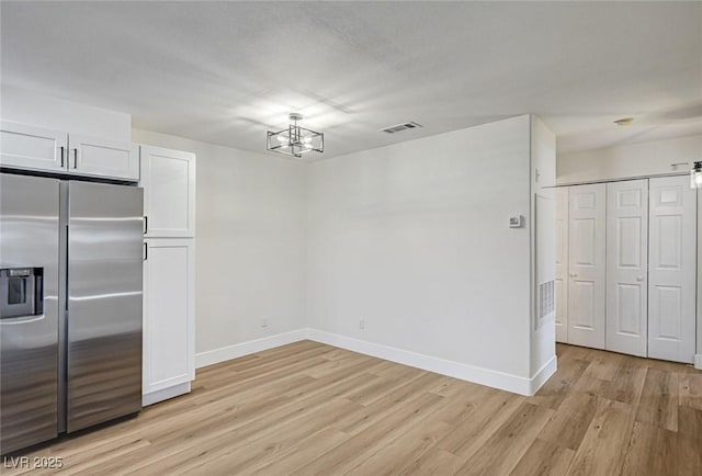 2725 S Nellis Blvd Unit 2036, Las Vegas, NV 89121 - unfurnished dining area featuring light wood-style floors, a chandelier, and baseboards