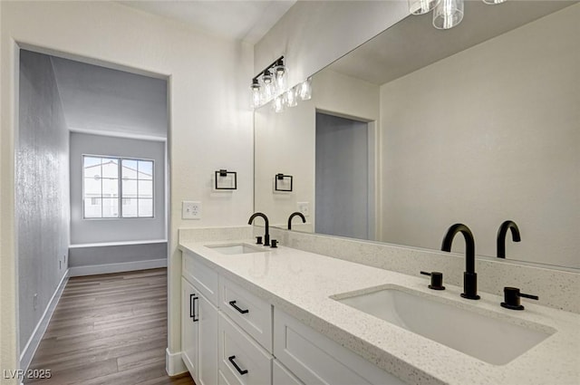 2725 S Nellis Blvd Unit 2036, Las Vegas, NV 89121 - full bath with wood finished floors, baseboards, and double vanity