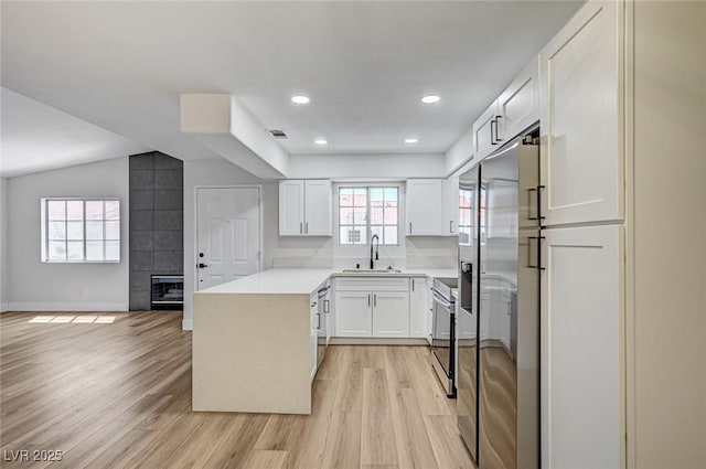 2725 S Nellis Blvd Unit 2036, Las Vegas, NV 89121 - kitchen featuring a sink, light wood finished floors, white cabinets, light countertops, and open floor plan