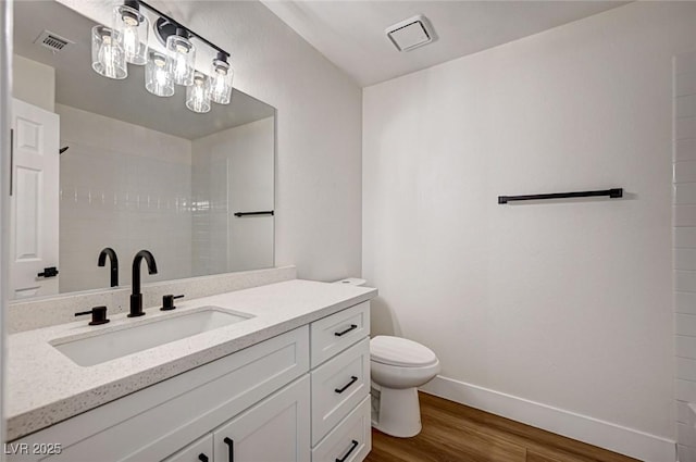 2725 S Nellis Blvd Unit 2036, Las Vegas, NV 89121 - full bath featuring wood finished floors, baseboards, toilet, tiled shower, and vanity