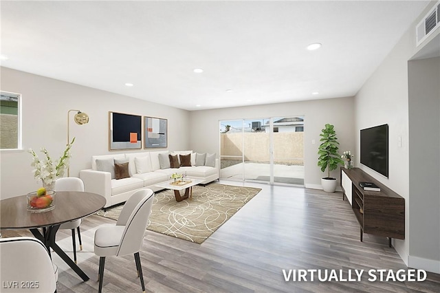 living area featuring wood finished floors, recessed lighting, and baseboards
