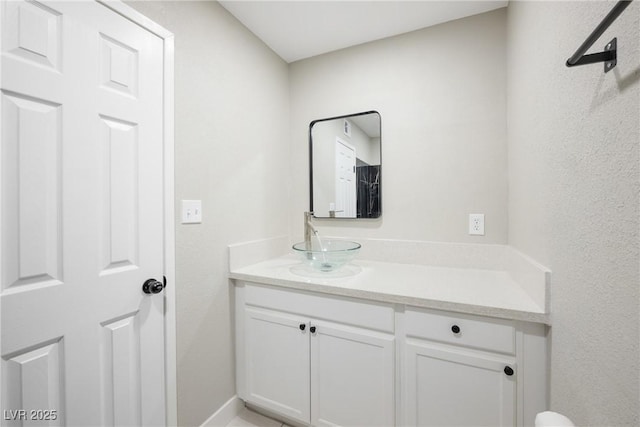 bathroom featuring vanity and baseboards