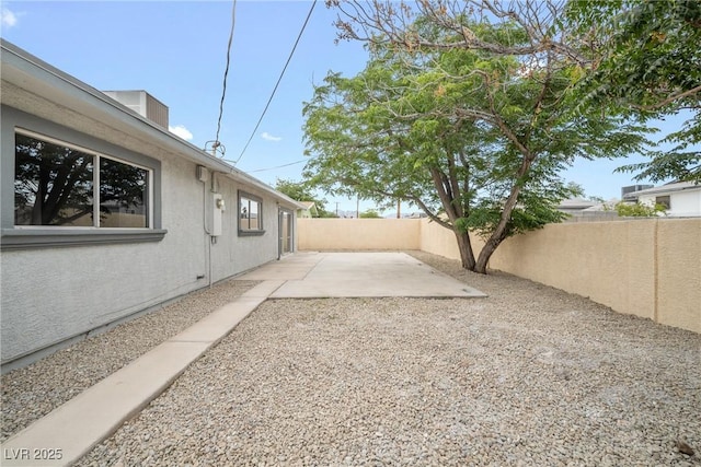 fenced backyard featuring a patio