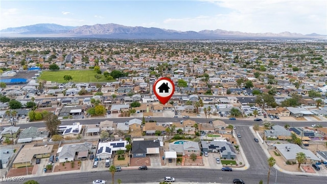 aerial overview of property's location featuring a mountain backdrop and nearby suburban area