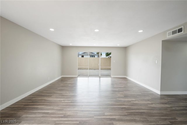 spare room featuring wood finished floors, recessed lighting, and baseboards
