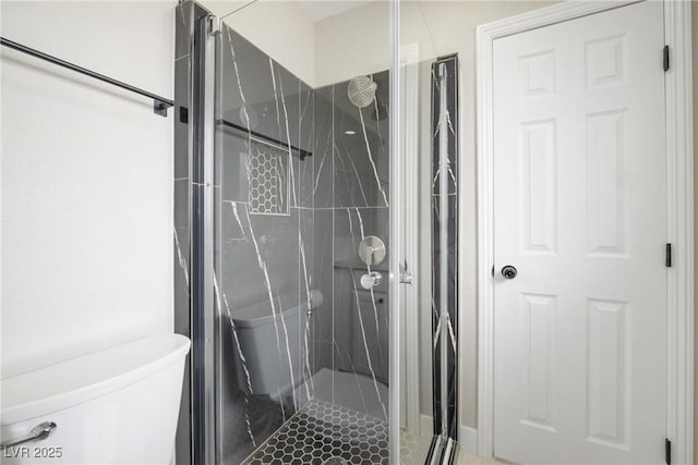full bathroom featuring a shower stall and toilet
