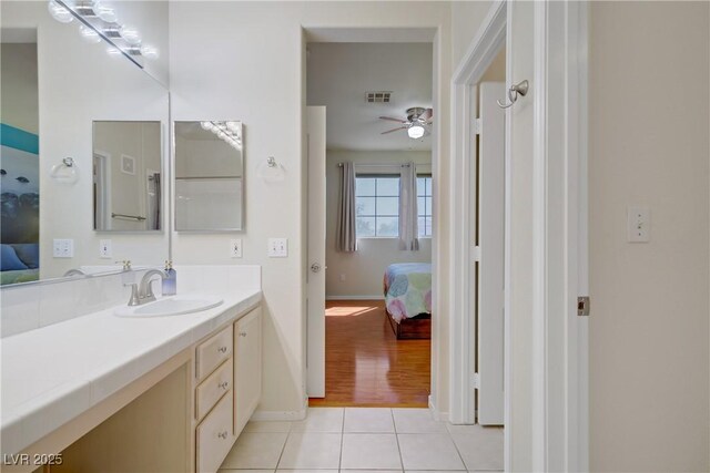 2325 Windmill Pkwy Unit 321, Henderson, NV 89074 - ensuite bathroom featuring vanity, a ceiling fan, tile patterned floors, and baseboards