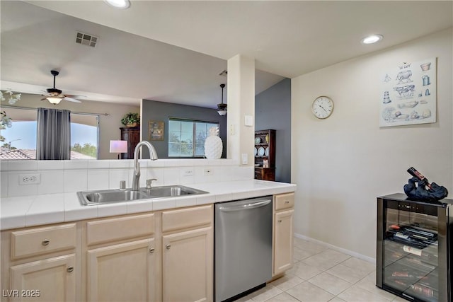 2325 Windmill Pkwy Unit 321, Henderson, NV 89074 - kitchen featuring dishwasher, beverage cooler, a ceiling fan, a sink, and tile counters