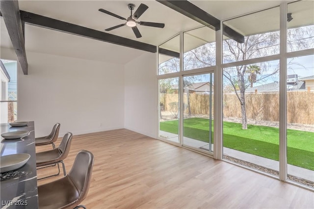 sunroom / solarium featuring beam ceiling