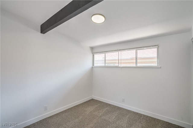 empty room featuring carpet floors, baseboards, and beamed ceiling