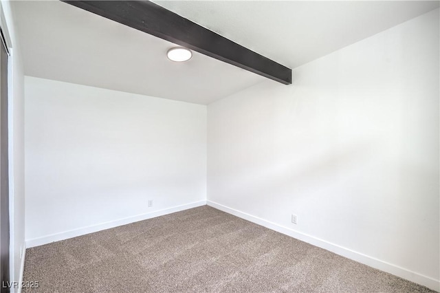 unfurnished room with beam ceiling, carpet, and baseboards