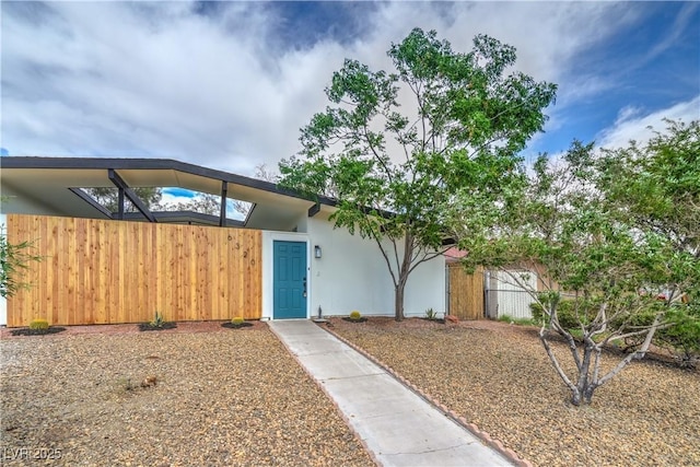 view of front of house featuring fence