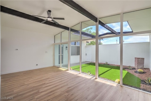unfurnished sunroom with a ceiling fan