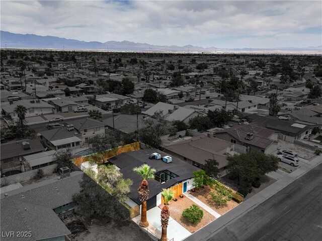 aerial view of residential area featuring a mountainous background