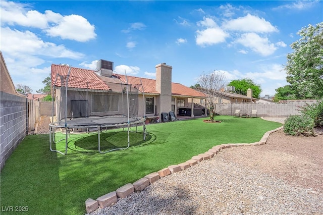5884 Deer Valley Dr, Las Vegas, NV 89156 - back of house with a trampoline, a tiled roof, a chimney, and central AC unit
