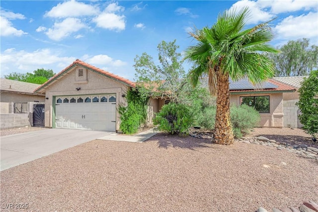 5884 Deer Valley Dr, Las Vegas, NV 89156 - view of front of property featuring an attached garage, solar panels, driveway, and stucco siding