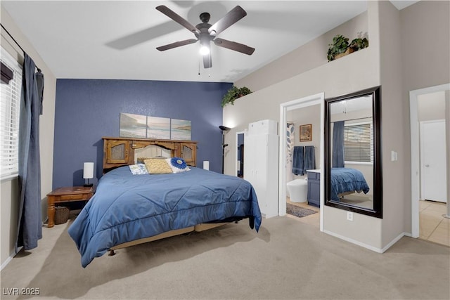 5884 Deer Valley Dr, Las Vegas, NV 89156 - carpeted bedroom featuring baseboards, ensuite bath, a ceiling fan, and vaulted ceiling