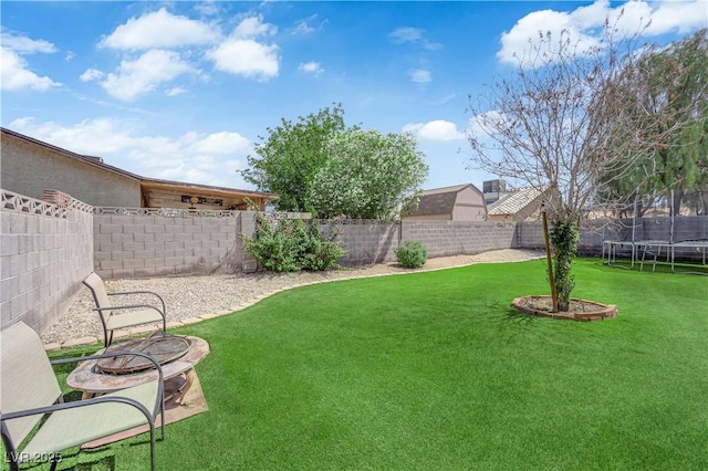 5884 Deer Valley Dr, Las Vegas, NV 89156 - view of yard with a trampoline and a fire pit