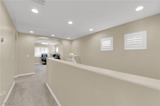 7183 Majestic Bluff Pl, Las Vegas, NV 89113 - hallway featuring arched walkways, light colored carpet, baseboards, and recessed lighting