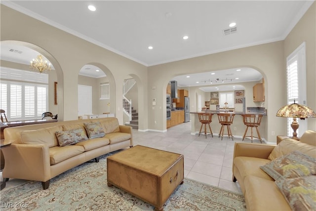 7183 Majestic Bluff Pl, Las Vegas, NV 89113 - living room featuring arched walkways, light tile patterned floors, recessed lighting, baseboards, and ornamental molding