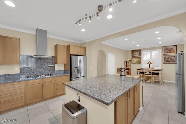 7183 Majestic Bluff Pl, Las Vegas, NV 89113 - kitchen featuring stainless steel appliances, arched walkways, wall chimney range hood, light tile patterned floors, and ornamental molding