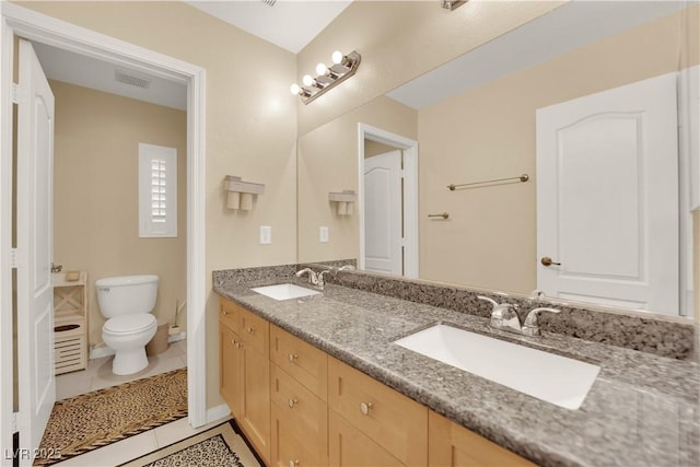 7183 Majestic Bluff Pl, Las Vegas, NV 89113 - full bath with double vanity, toilet, and tile patterned floors