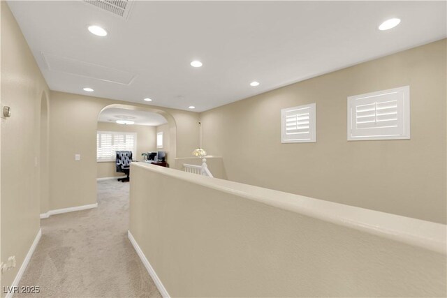 7183 Majestic Bluff Pl, Las Vegas, NV 89113 - hallway with arched walkways, light colored carpet, recessed lighting, and baseboards