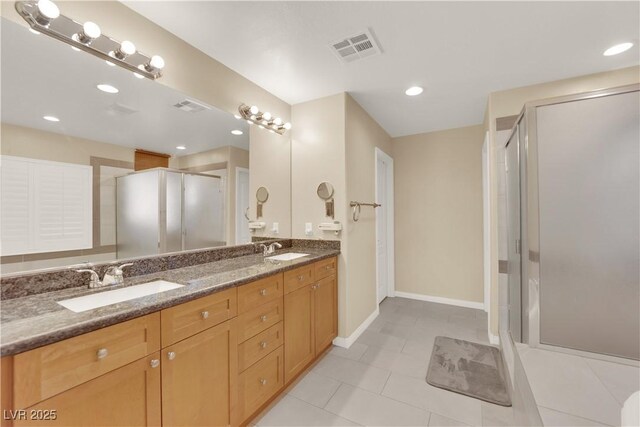 7183 Majestic Bluff Pl, Las Vegas, NV 89113 - full bathroom with double vanity, a shower stall, tile patterned floors, baseboards, and recessed lighting