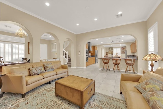 7183 Majestic Bluff Pl, Las Vegas, NV 89113 - living room with arched walkways, recessed lighting, light tile patterned flooring, baseboards, and ornamental molding