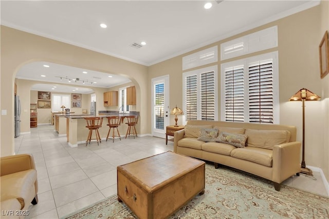 7183 Majestic Bluff Pl, Las Vegas, NV 89113 - living area featuring arched walkways, crown molding, recessed lighting, light tile patterned floors, and baseboards
