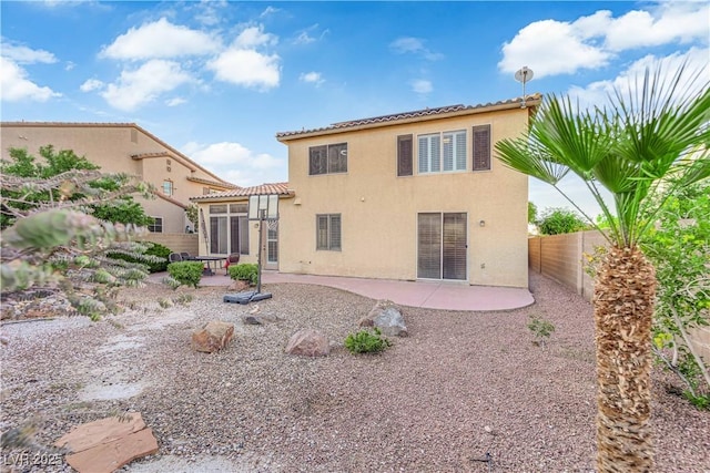 7183 Majestic Bluff Pl, Las Vegas, NV 89113 - rear view of house with a patio, stucco siding, a tiled roof, and a fenced backyard