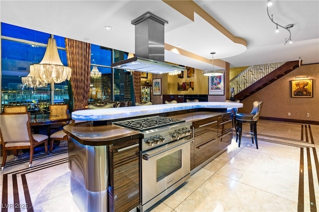 360 E Desert Inn Rd Unit 1901, Las Vegas, NV 89109 - kitchen with high end range, island exhaust hood, a chandelier, and hanging light fixtures