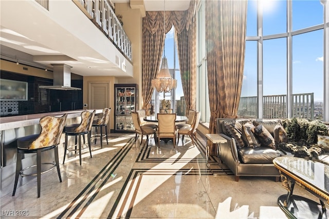 360 E Desert Inn Rd Unit 1901, Las Vegas, NV 89109 - living room with inlaid floor details, a high ceiling, marble tiled flooring, and plenty of natural light