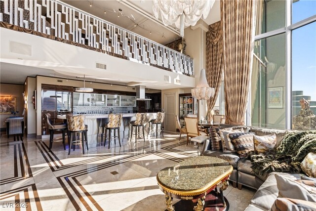 360 E Desert Inn Rd Unit 1901, Las Vegas, NV 89109 - living room with a high ceiling, inlaid floor details, and tile patterned flooring