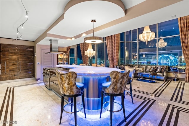 360 E Desert Inn Rd Unit 1901, Las Vegas, NV 89109 - bar with inlaid floor details, island exhaust hood, a chandelier, and high end stove