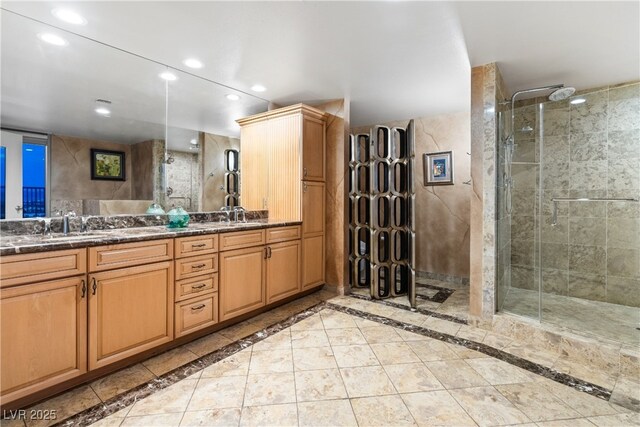 360 E Desert Inn Rd Unit 1901, Las Vegas, NV 89109 - bathroom featuring a shower stall, recessed lighting, double vanity, and inlaid floor details