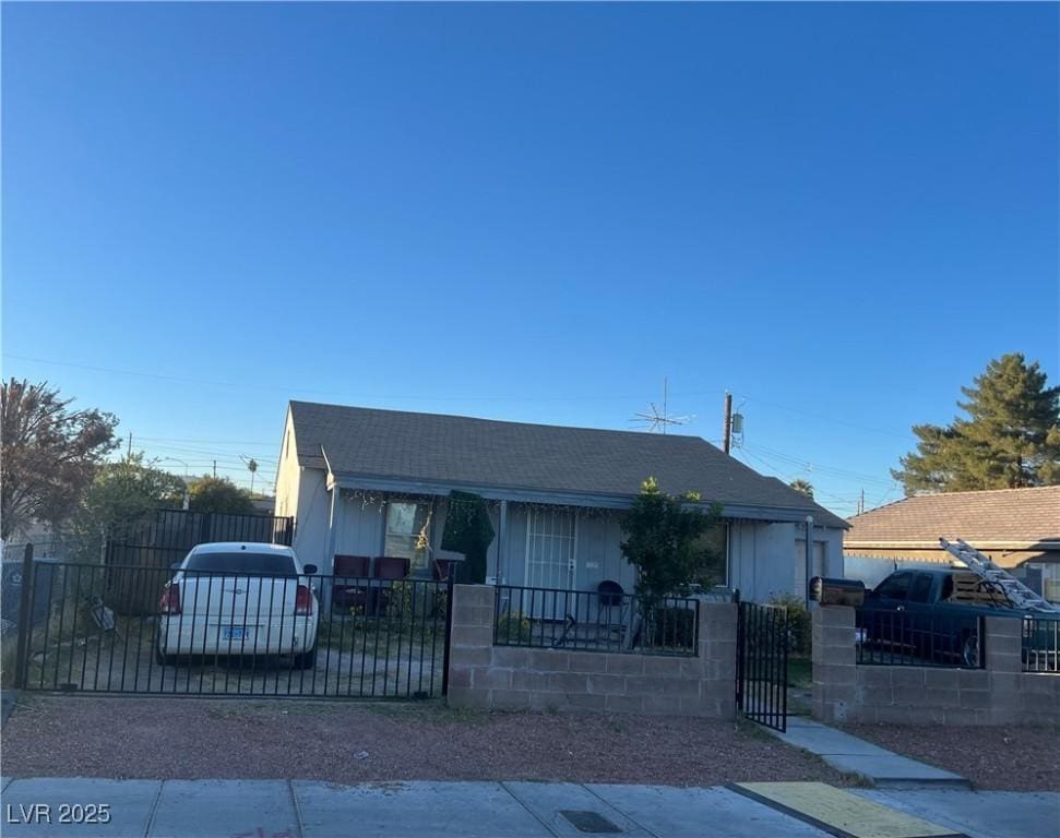 212 S 16th St, Las Vegas, NV 89101 - view of front of home featuring a shingled roof, a fenced front yard, and a gate