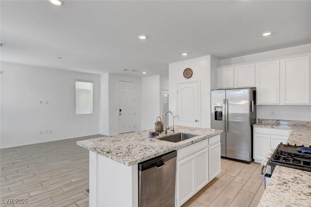 10735 Galveston Bay St, Las Vegas, NV 89179 - kitchen featuring appliances with stainless steel finishes, a sink, wood finish floors, a kitchen island with sink, and recessed lighting
