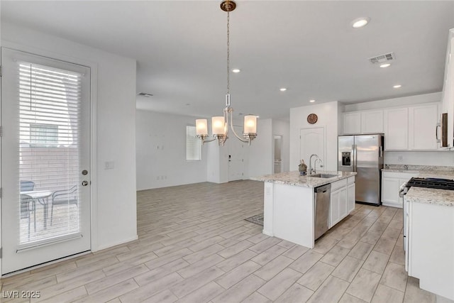 10735 Galveston Bay St, Las Vegas, NV 89179 - kitchen featuring stainless steel appliances, a sink, a chandelier, a kitchen island with sink, and light wood-type flooring