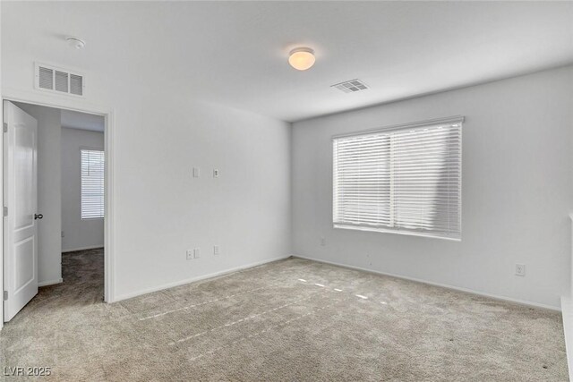 10735 Galveston Bay St, Las Vegas, NV 89179 - carpeted empty room featuring plenty of natural light and baseboards