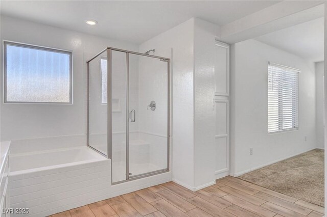 10735 Galveston Bay St, Las Vegas, NV 89179 - full bathroom with a shower stall, a bath, wood finished floors, and baseboards