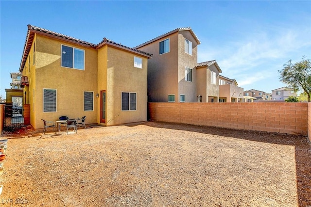 10735 Galveston Bay St, Las Vegas, NV 89179 - back of property featuring stucco siding, a fenced backyard, and a tile roof