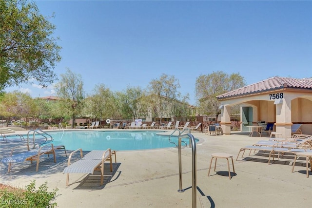 10735 Galveston Bay St, Las Vegas, NV 89179 - community pool featuring a patio area and fence