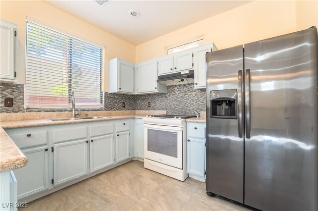 9753 Villa Lorena Ave, Las Vegas, NV 89147 - kitchen featuring stainless steel refrigerator with ice dispenser, white gas stove, a sink, under cabinet range hood, and backsplash