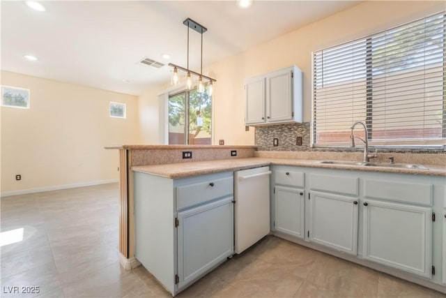 9753 Villa Lorena Ave, Las Vegas, NV 89147 - kitchen with white dishwasher, a sink, a peninsula, decorative backsplash, and recessed lighting