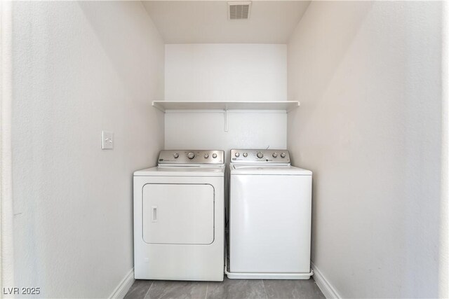 9753 Villa Lorena Ave, Las Vegas, NV 89147 - washroom featuring washing machine and clothes dryer and baseboards